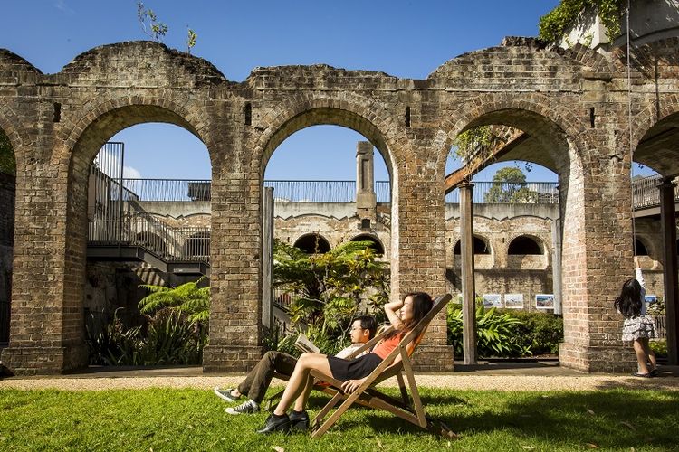 Couple relaxing in the heritage-listed Paddington Reservoir Gardens in Paddington, Sydney.