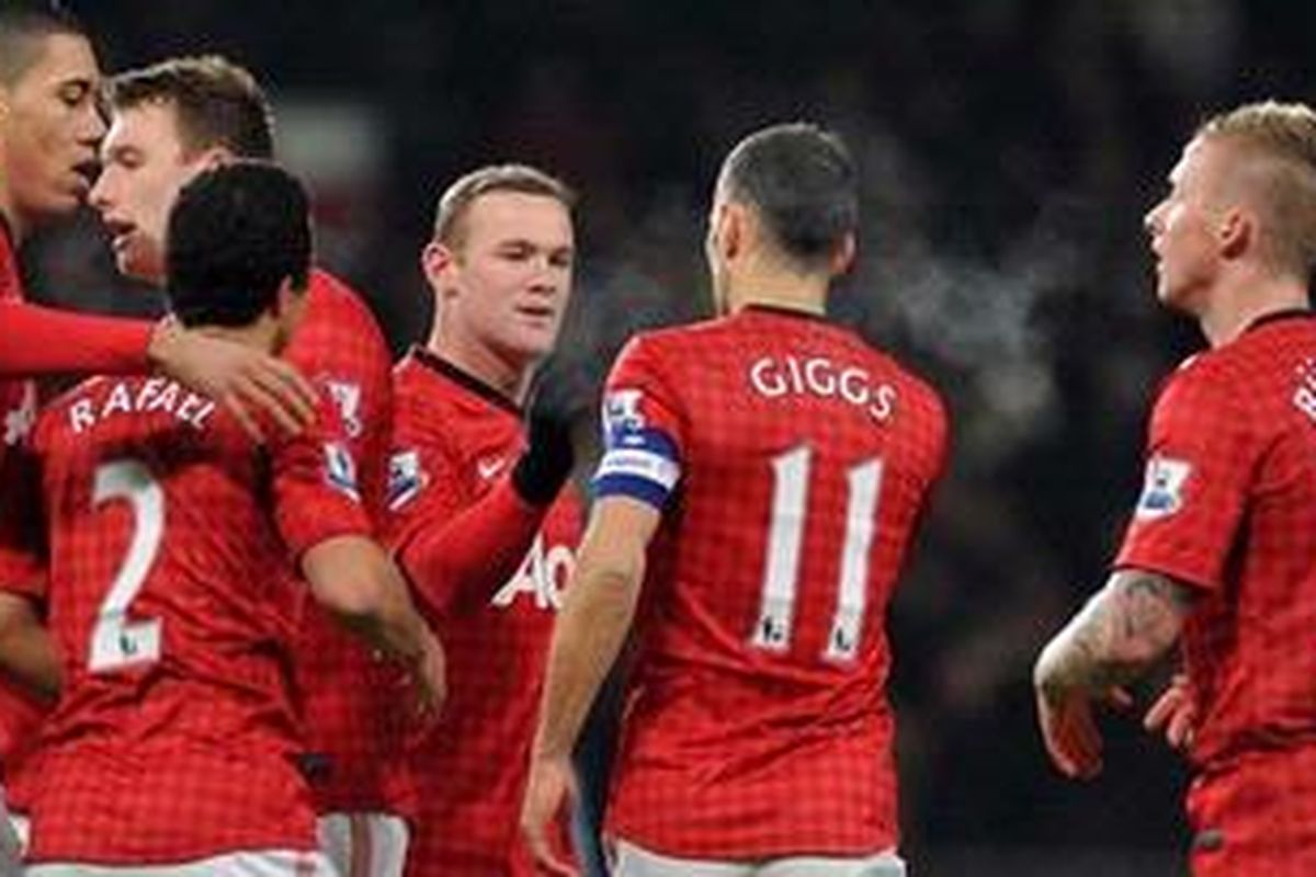 Striker Manchester United dari Inggris, Wayne Rooney (ketiga dari kanan), melakukan selebrasi bersama kapten tim, gelandang dari Wales, Ryan Giggs (kedua dari kanan), setelah mencetak gol pada partai ulangan babak ketiga Piala FA ke gawang West Ham United di Stadion Old Trafford, Rabu (16/1/2013). MU akhirya menang 1-0.  