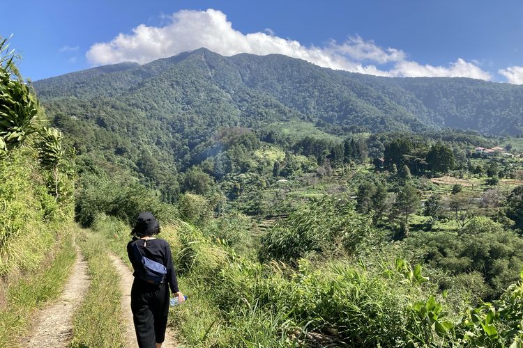 Seorang wisatawan sedang trekking di jalur trekking kaki Gunung Salak yang berlokasi di Desa Pasirjaya, Kecamatan Cigombong, Kabupaten Bogor, Kamis (27/5/2021).