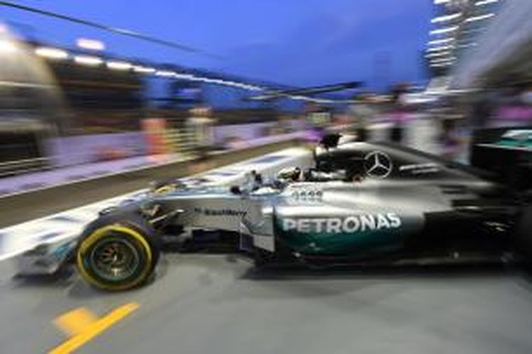 Pebalap Mercedes asal Inggris, Lewis Hamilton, meninggalkan pit pada sesi latihan bebas pertama GP Singapura di Sirkuit Marina Bay Street, Jumat (19/9/2014).