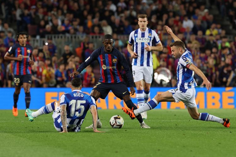 Penyerang Barcelona Ousmane Dembele (tengah) dibayangi oleh pemain Real Sociedad dalam laga laga lanjutan Liga Spanyol musim 2022-2023. Laga Barcelona vs Real Sociedad berlangsung di Stadion Camp Nou pada Minggu (21/5/2023) dini hari WIB.