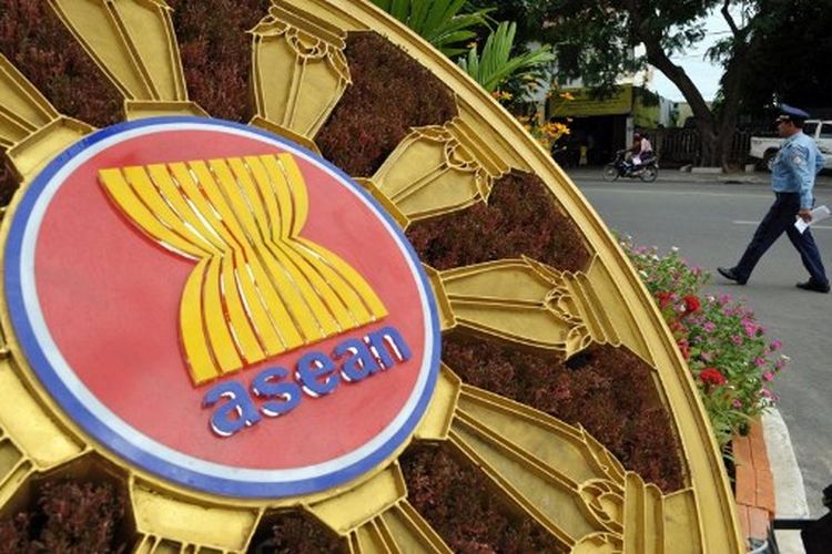 (File) A Cambodian police officer (R) walks past the ASEAN logo in front of the Peace Palace during the 45th Association of Southeast Asian Nations (ASEAN) Foreign Ministers' Meeting (AMM) in Phnom Penh on July 8, 2012. The US-China rivalry and growing fears of a new North Korean nuclear test will loom over a meeting this week of Southeast Asian leaders attended by US President Joe Biden.