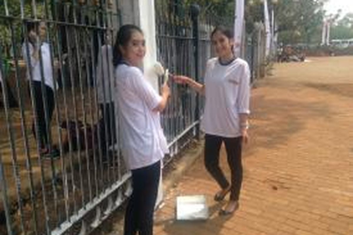Komunitas Ikatan Abang None Jakarta turut mengecat pagar Kawasan Monas, Jakarta, Selasa (10/11/2015).
