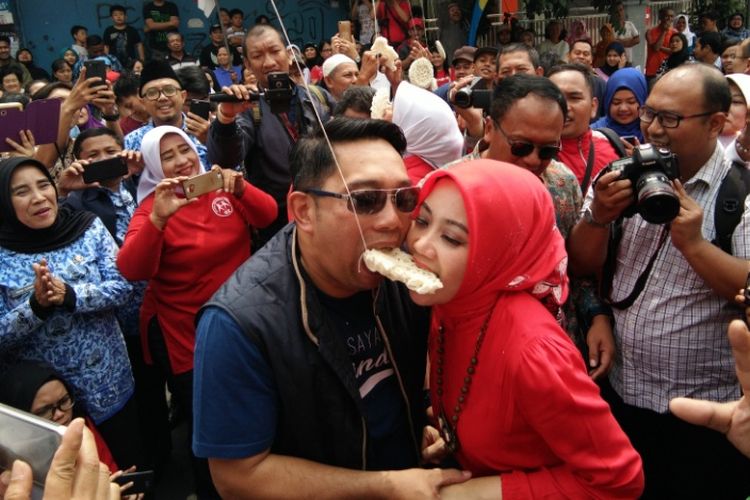 Wali Kota Bandung Ridwan Kamil bersama istrinya, Atalia Praratya saat mengikuti lomba makan kerupuk pada acara peringatan HUT ke-72 RI di kawasan Cibadak, Bandung, Kamis (17/8/2017)