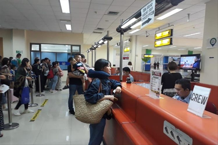 Petugas Kantor Imigrasi Kelas I TPI Manado melalukan pemeriksaan keimigrasian terhadap ratusan warga negara (WN) China di Tempat Pemeriksaan Imigrasi Bandar Udara Internasional Sam Ratulangi Manado, Jumat (26/7/2019)