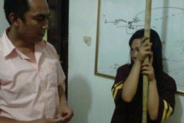 Ratimah (31) ibu rumah tangga yang terjerat kasus narkoba berikut barang bukti bambu jemuran dan tiga paket kecil sabu-sabu diperiksa Kanit Reskrim Iptu Iwan Gunawan di Polsek SU I Palembang, Kamis (12/12/2013). 
