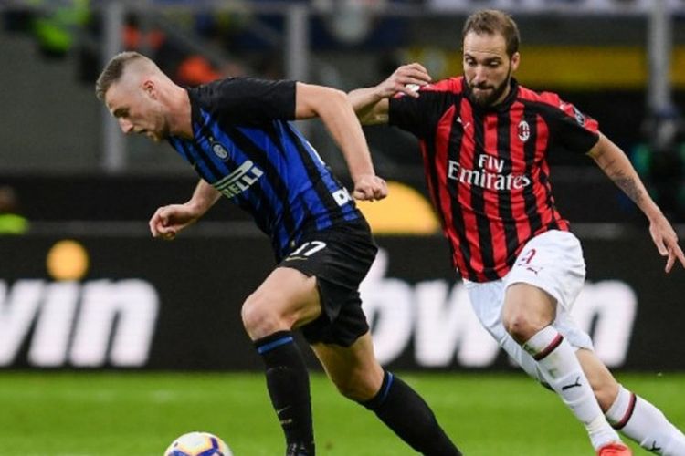 Gonzalo Higuain (kanan) membayangi bek Milan Skriniar dalam partai Liga Italia antara Inter Milan vs AC Milan di Giuseppe Meazza, 21Oktober 2018.
