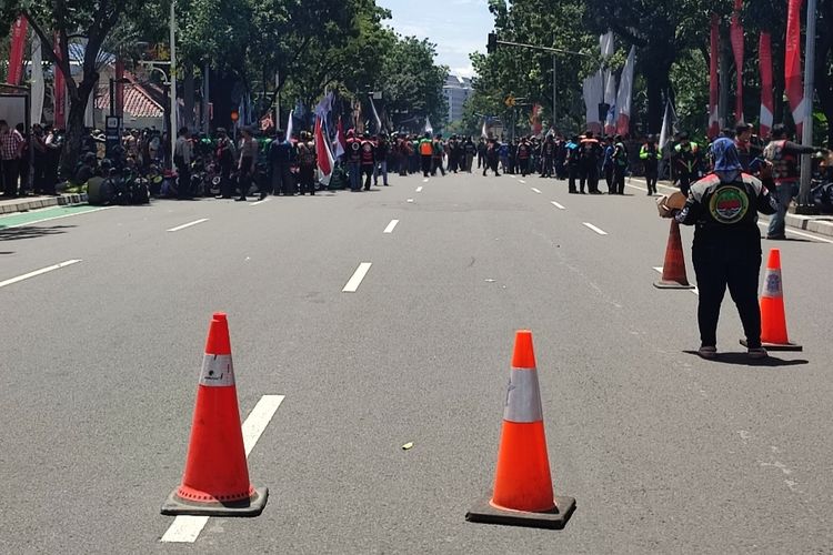 Jalan Medan Merdeka Selatan ke arah Medan Merdeka Barat ditutup polisi karena adanya aksi unjuk rasa dari driver ojek online tepat di depan Gedung Balaikota, Rabu (8/2/2023) siang. Para massa aksi tersebut menolak wacana aturan jalan berbayar di Jakarta.