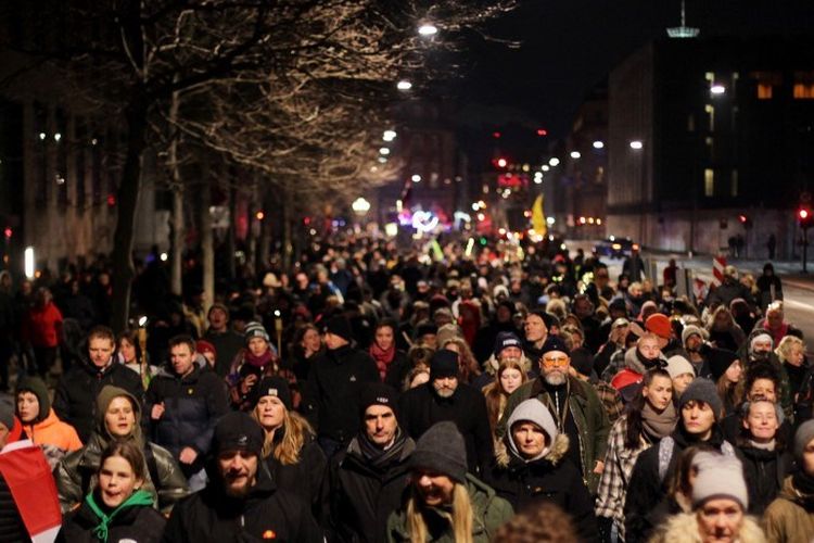 Demonstran mengambil bagian dalam pawai untuk memprotes pembatasan Covid-19 di Denmark di Kopenhagen pada 9 Januari 2022, menandai ulang tahun pertama gerakan anti-vaksinasi 'Men in Black'.