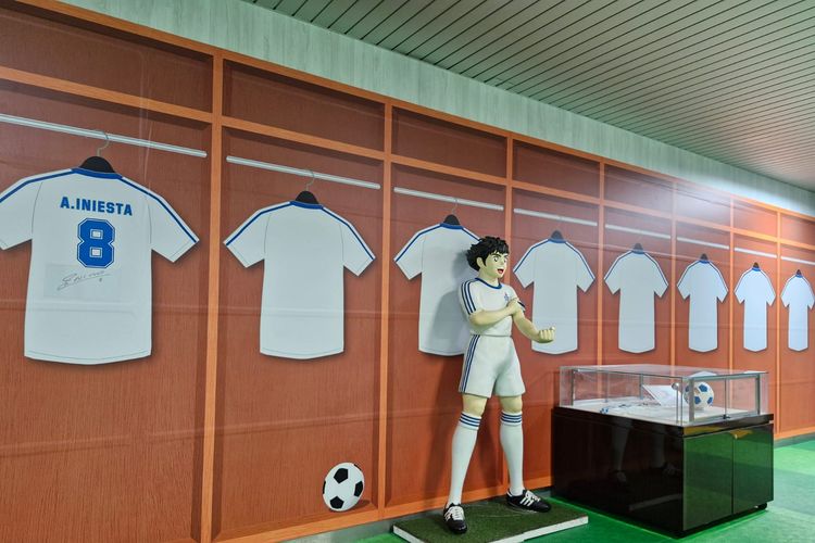 Patung karakter Tsubasa Ozora berdiri di dinding dengan suasana ruang ganti, dengan kaus bernomor punggung 8 milik pesepakbola Spanyol Andreas Iniesta di Stasiun Yotsugi di Tokyo, Jepang, Selasa (7/11/2023).