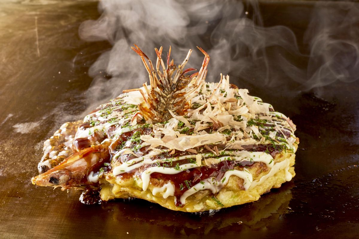 Sepiring okonomiyaki isi ayam dengan topping saus khas Jepang, mayones, dan taburan bonito flakes yang menggoda