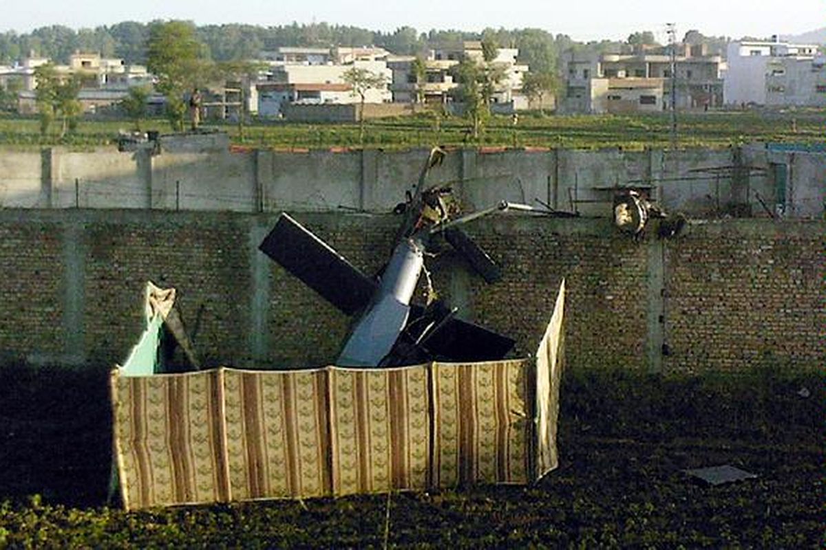 Reruntuhan bagian ekor helikopter yang digunakan pasukan Navy SEALs AS untuk menyerang rumah persembunyian Osama bin Laden tampak teronggok di salah satu sudut kompleks rumah di Abbottabad, Pakistan, itu, Senin (2/5). Para pakar penerbangan menduga ini adalah bagian dari helikopter tipe baru yang berkemampuan 