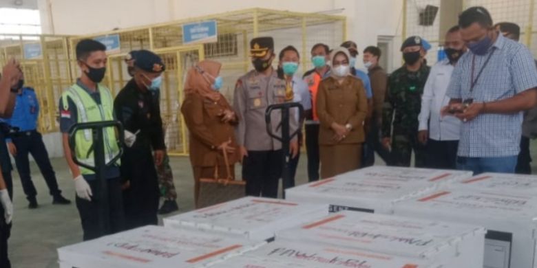 Members of the Indonesian Police and Military escort the Covid-19 vaccine from Sinovac Biotech Ltd in Halu Oleo Airport in Kendari, Southeast Sulawesi. 