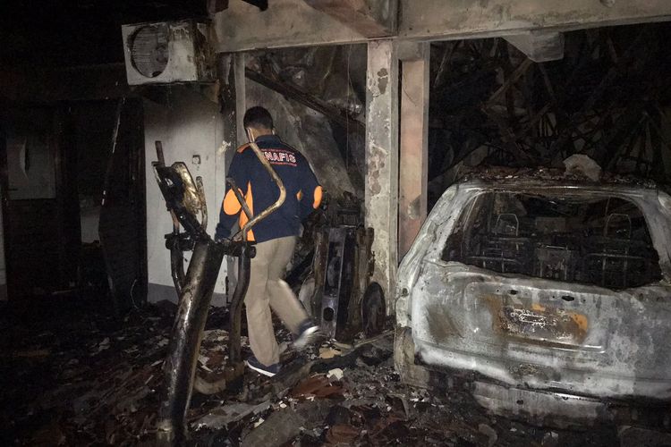 Petugas kepolisian saat melakukan olah TKP di rumah yang dilanda kebakaran di  Ratna Gang Tunjung No.17,  Banjar Tatasan Kelurahan Tonja, Kecamatan Denpasar utara, Denpasar, Bali, Jumat (15/4/2022). 