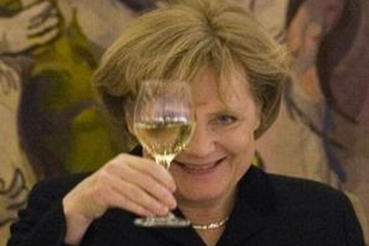 Kanselir Jerman Angela Merkel mengangkat gelas saat berbicara di depan Knesset, Selasa (18/3).
