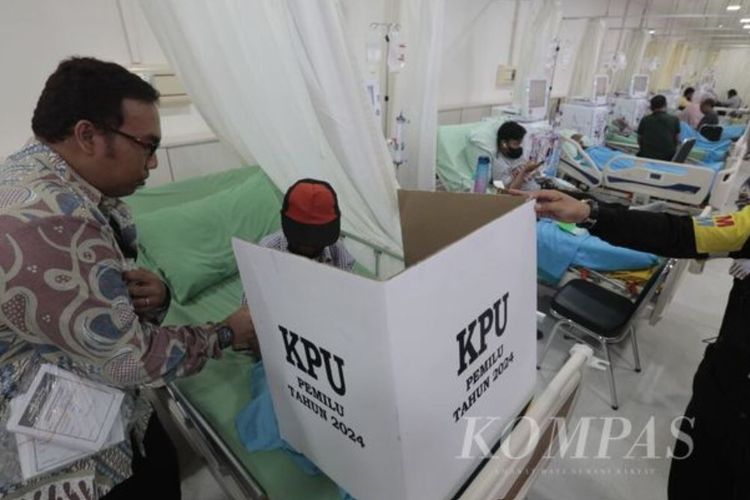 Petugas KPPS TPS 901 memandu pasien yang hendak mencoblos melalui pelayanan jemput bola di RS Dr Cipto Mangunkusumo, Jakarta, Rabu (14/2/2024).