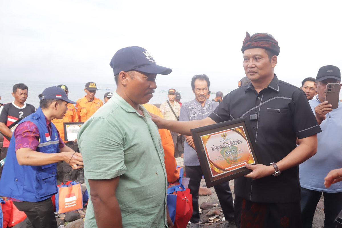 Bupati Jembrana, I Made Kembang Hartawan menyerahkan penghargaan kepada 22 orang di pesisir Pantai Pebuahan, desa Banyubiru, Selasa (8/7/2025).
