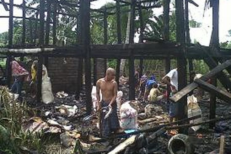 Sejumlah warga di Kabupaten Bone, Sulawesi Selatan berupaya mencari barang berharga diantara puing rumah milik lansia yang ludes dilalap api. Sabtu, (18/01/2014).