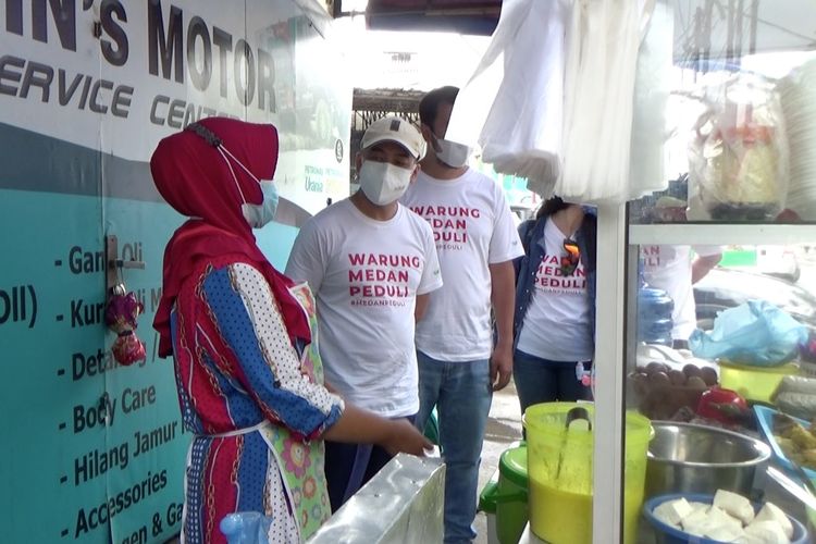 Sejumlah anak muda dari gerakan Warung Medan Peduli memborong dagangan pedagang kecil kemudian dibagikan gratis kepada warga.