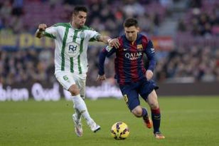 Penyerang Barcelona Lionel Messi (kanan) berebut bola dengan gelandang Cordoba Luso pada pertandingan Primera Division, di Camp Nou, Sabtu (20/12/2014).