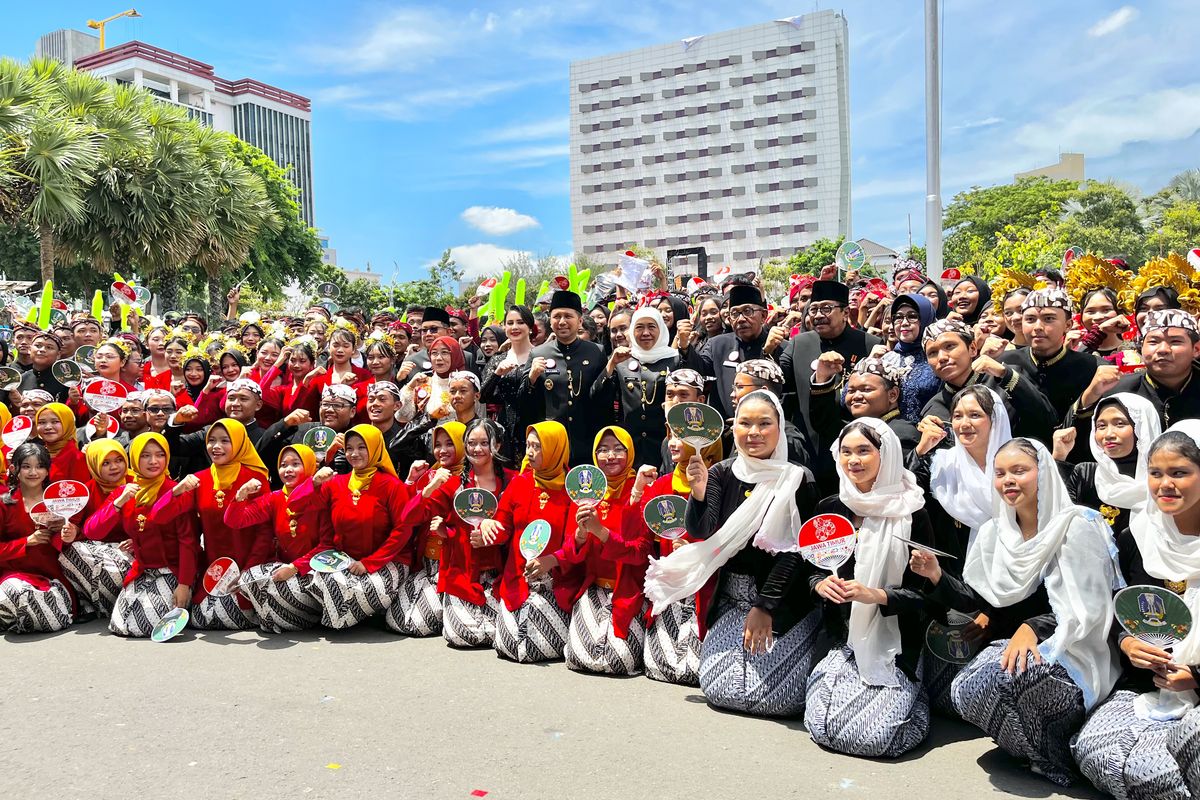 Gubernur Jawa Timur Khofifah Indar Parawansa bersama Wakil Gubernur Jatim Emil Dardak saat berfoto bersama para penari dan paduan suara gabungan dalam peringatan Hari Jadi Jatim ke-80 di Gedung Grahadi, Minggu (12/10/2025).