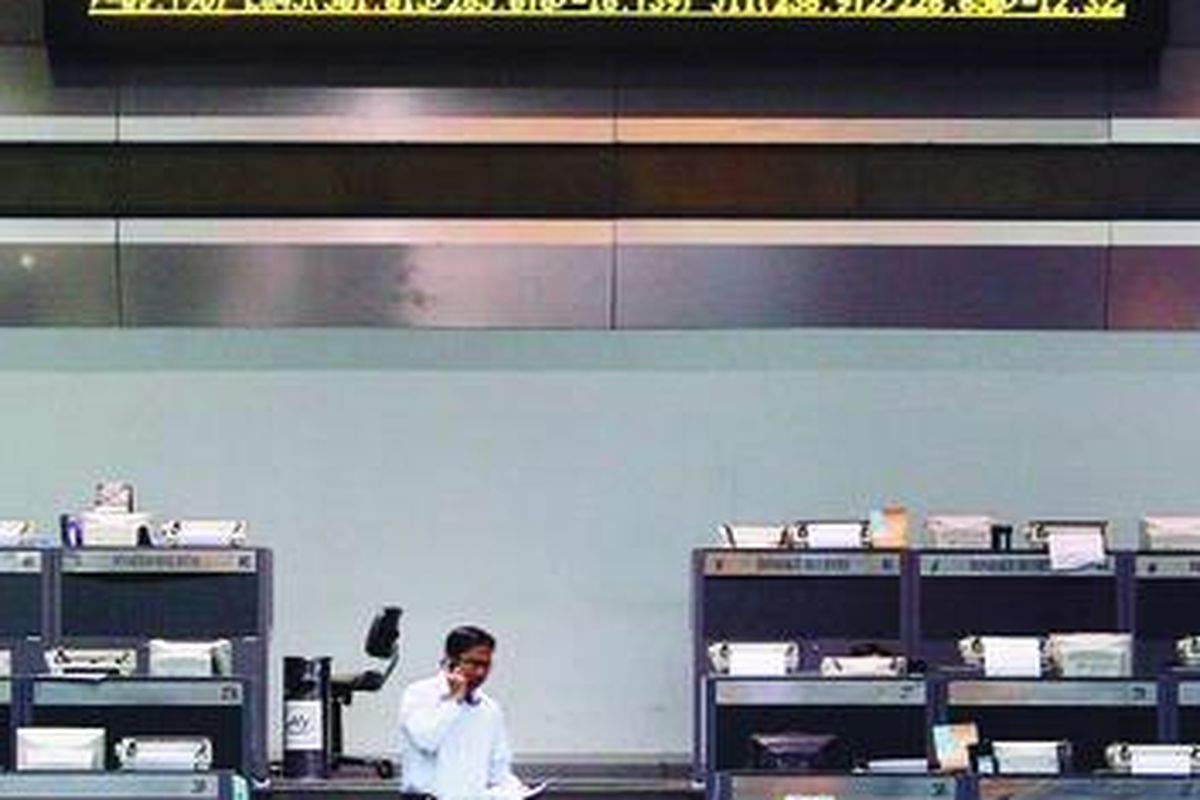 Seorang pialang saham beraktivitas di lantai Bursa Efek Indonesia, Jakarta.