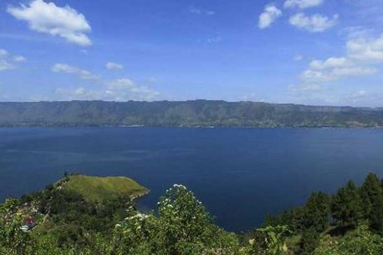 Danau Toba terlihat dari Parapat, Kabupaten Simalungun, Sumatera Utara, Senin (25/7/2011). Danau Toba adalah danau terbesar di Indonesia. Danau hasil volcano tektonik terbesar di dunia, dengan panjang danau 87 kilometer dan lebar 27 kilometer, terbentuk dari letusan gunung berapi raksasa (supervolcano) yang terjadi sekitar 75 ribu tahun lalu. 