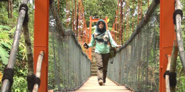 Salah satu pengunjung melintasi jembatan gantung kawasan wisata Banyu Nget, Trenggalek, Jatim yang diberi nama jembatan Kangen.