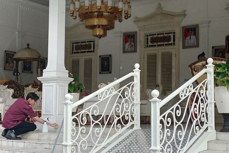 Seorang pekerja sedang membersihkan selasar Pendopo Bupati Cianjur. Di balik kemegahan dan nilai sejarahnya, kantor kerja bupati ini menyimpan kisah tragis pembunuhan Bupati Cianjur ke-3 Raden Aria Wiratanu Datar III di pertengahan Abad ke-18.