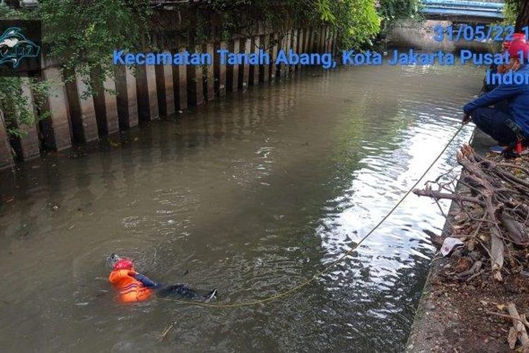 Petugas damkar mengevakuasi motor warga yang tercemplung di kali kawasan Kebon Kacang, Tanah Abang, Jakarta Pusat pada Selasa (31/5/2022). 