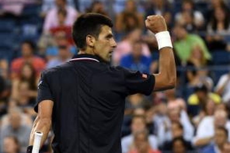 Petenis Serbia, Novak Djokovic, mengepalkan tangan setelah meraih poin ketika melawan petenis Inggris, Andy Murray, pada perempat final AS Terbuka di USTA Billie Jean King National Center, Rabu (3/9/2014).