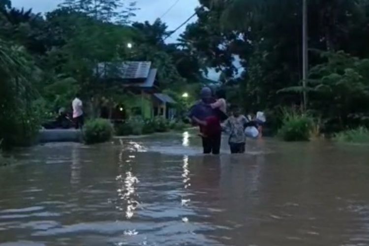 Warga di Desa Pabbaresseng, Kecamatan Bua, Kabupaten Luwu, Sulawesi Selatan, mengungsi ke tempat aman untuk menghindari banjir yang lebih tinggi, Senin (8/5/2023) petang