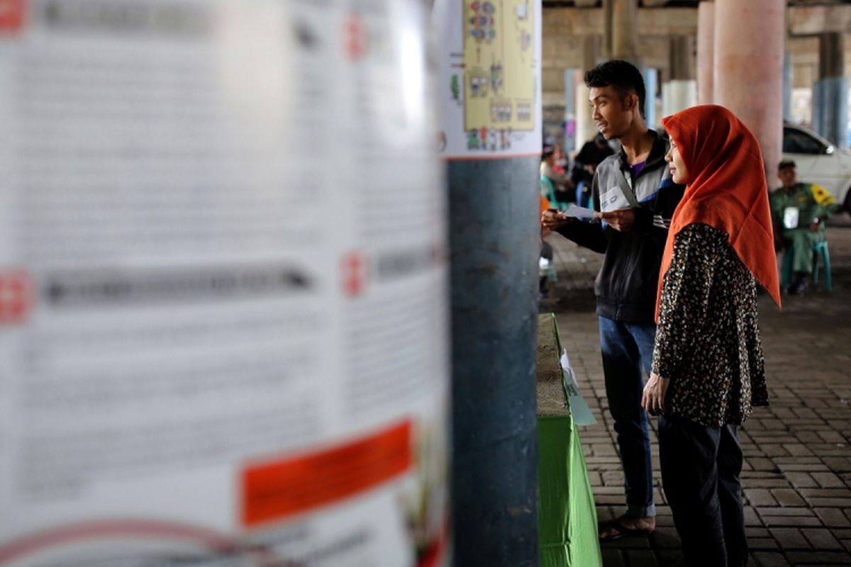 Suasana saat warga melakukan pencoblosan di TPS 20 dan 21 di kolong jembatan kawasan Penjaringan, Jakarta, Rabu, (19/4/2017). Pasangan calon gubernur-wakil gubernur DKI Jakarta, Anies Baswedan- Sandiaga Uno berdasarkan hasil quick count dari berbagai lembaga survei unggul dibanding pasangan calon Basuki Tjahaja Purnama- Djarot Saiful Hidayat.