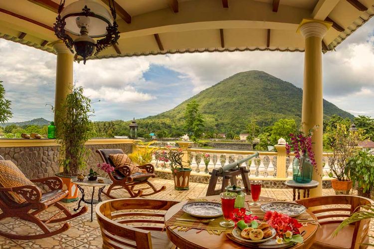 Cilu Bintang Estate colonial style accomodation. The Rata suite private terrace overlooks 16th century Dutch East Indies Fort Nassau with view of Gunung Api volcano. Imagine breakfast or a cool sundowner here.