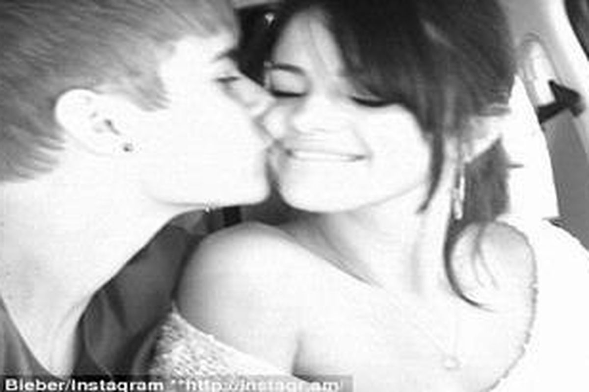 Romance: Justin Bieber tenderly kisses his girlfriend Selena Gomez for her birthday over the weekend in a snap he posted on Instagram   