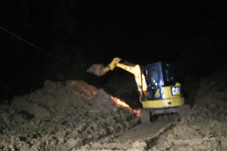 Alat berat berupaya menyingkirkan material longsor yang menutup badan jalan lintas selatan Cianjur, Jawa Barat, Kamis (19/3/2020) malam.
