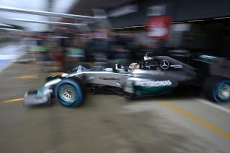 Pebalap Mercedes asal Inggris, Lewis Hamilton, keluar dari garasi di paddock Sirkuit Silverstone, pada sesi latihan ketiga GP Inggris, Sabtu (5/7/2014).