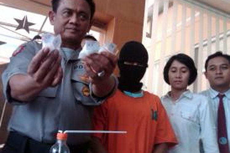 Seorang pengedar sabu besar, Siti Aminah atau Putri (25) (bertopeng), ditangkap petugas dari Satreskoba Polres Jember, Senin (3/2/2014) 