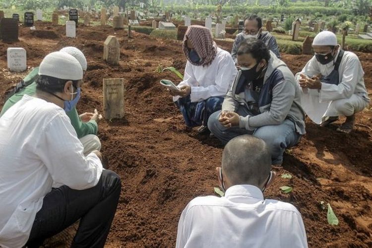 Pihak keluarga berdoa setelah pemakaman jenazah korban COVID-19 di TPU Pondok Rajeg, Kabupaten Bogor, Jawa Barat, Selasa (29/6/2021).