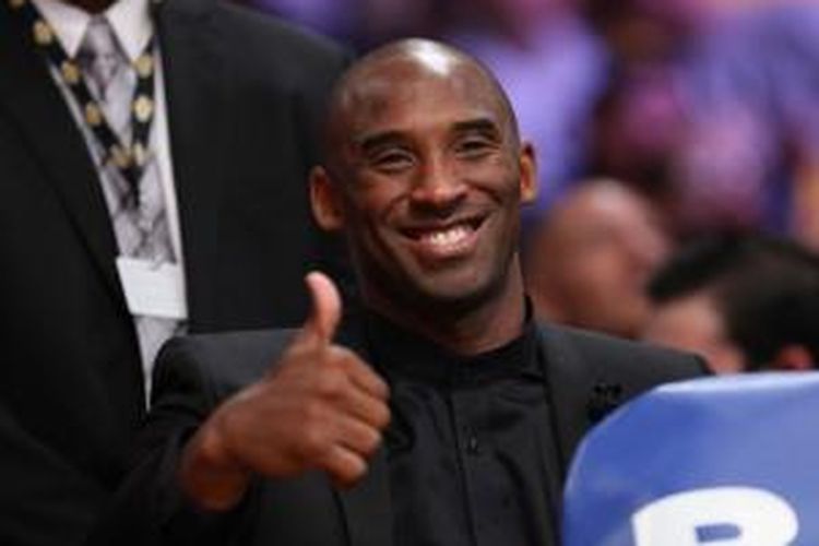 Pebasket Los Angeles Lakers, Kobe Bryant mengacungkan jempol saat menyaksikan pertandingan antara timnya dan Los Angeles Clippers di Staples Center, Senin (29/10/2013).