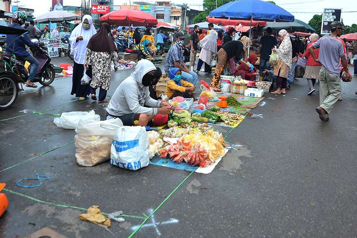 Suasana di lapak relokasi Pasar Tradisional Lemabang Palembang, Sumatera Selatan, Selasa (5/5/2020). Pasar Tradisional Lemabang yang mulai menerapkan jaga jarak dengan menyediakan lapak relokasi ini terkendala kurangnya lahan bagi pedagang dan padatnya pembeli.