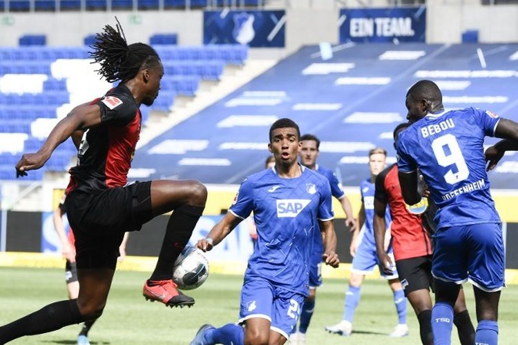  Bek asal Belgia Hertha Dedryck Boyata bersaing untuk merebut bola dengan pemain belakang Hoffenheim asal Jerman Kevin Akpoguma dan penyerang Togolese Ihlas Bebou selama pertandingan sepakbola divisi satu Jerman TSG 1899 Hoffenheim v Hertha Berlin pada 16 Mei 2020 di Sinsheim, barat daya Jerman sebagai Musim dimulai kembali setelah dua bulan absen karena pandemi coronavirus COVID-19 yang baru.