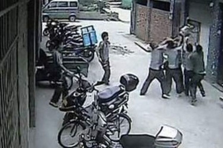 Foto yang diambil dari rekaman kamera CCTV ini memperlihatkan sejumlah pria menangkap seorang balita yang terjatuh dari sebuah apartemen yang berada di lantai lima sebuah gedung.