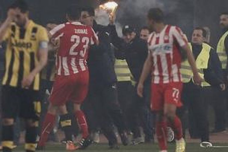 Sejumlah fans AEK Athena menyerbu lapangan pada laga derbi melawan Olympiakos di Piala Yunani. 