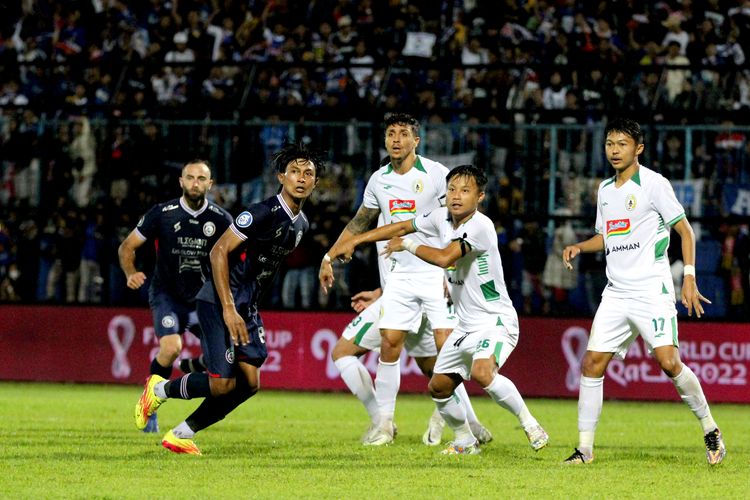 Pemain Arema FC Johan Ahmad Farizi siap berduet dengan pemain PSS Sleman Rifky Suryawan saat pertandingan pekan 3 Liga 1 2022-2023 yang berakhir dengan skor 0-0 di Stadion Kanjuruhan Kepanjen, Kabupaten Malang, Jumat (5/8/2022) malam.
