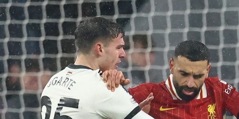 Penyerang Liverpool Mohamed Salah memisahkan gelandang Manchester United Manuel Ugarte dan penyerang Diogo Jota pada laga Liga Premier Inggris antara Liverpool dan Manchester United di Anfield, Liverpool, barat laut Inggris, 5 Januari 2025. 