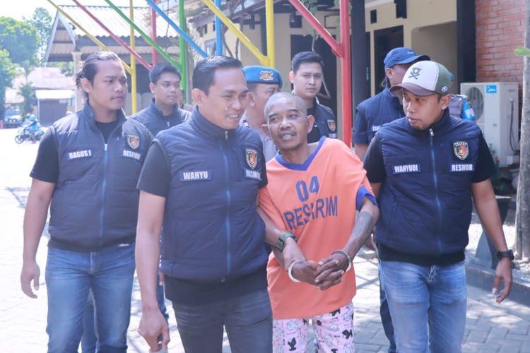 Tersangka S (53), pelaku pembunuhan terhadap DL (20), anak kandungnya sendiri, saat dibawa petugas di Mapolres Kediri, Jawa Timur, Senin (17/7/2023).
