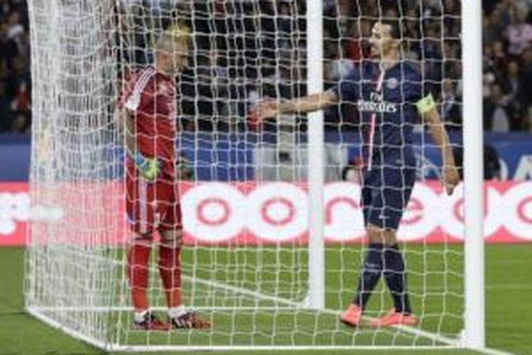 Penyerang Paris Saint-Germain, Zlatan Ibrahimovic (kanan), mencoba menyemangati kiper Saint-Etienne, Stephane Ruffier (kiri), yang melakukan blunder pada laga Ligue 1 di Parc des Princes, Paris, Minggu (31/8/2014).