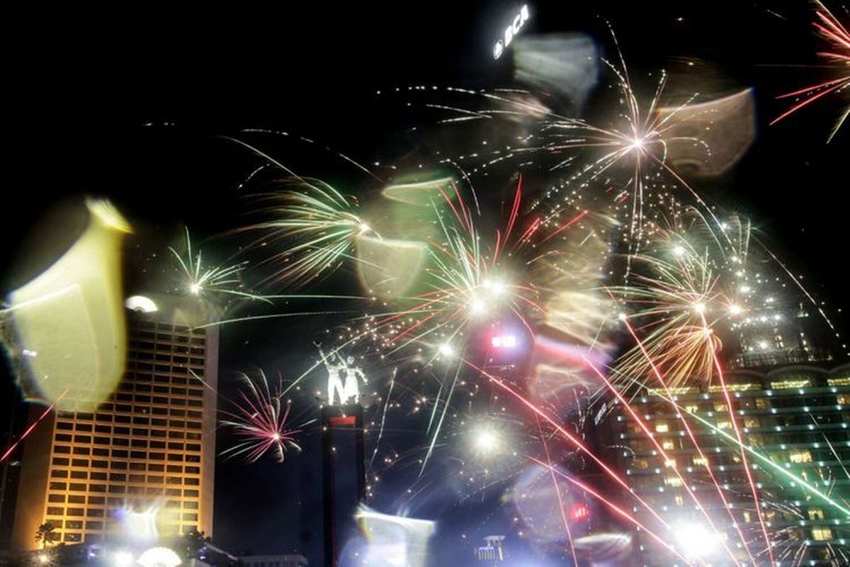 Suasana pesta kembang api saat malam tahun baru di kawasan Bundaran HI, Jakarta, Selasa (1/1/2019). Sejumlah warga ibukota dan sekitarnya memadati kawasan itu untuk merayakan malam pergantian tahun