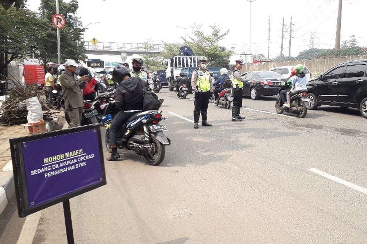 Samsat Jakarta Barat menggelar operasi razia gabungan pengesahan surat tanda nomor kendaraan (STNK) dan pembayaran pajak kendaraan di Jalan Lingkar Luar Barat, Cengkareng, Jakarta Barat pada Kamis (27/9/2018).